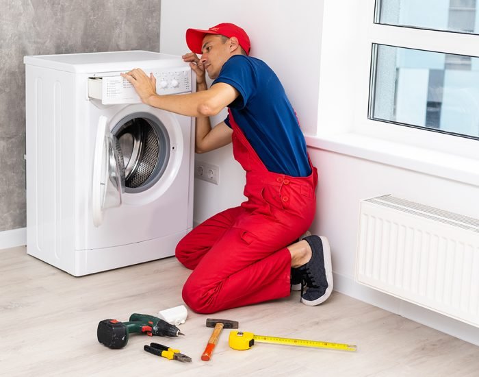 master repairs the broken washing machine